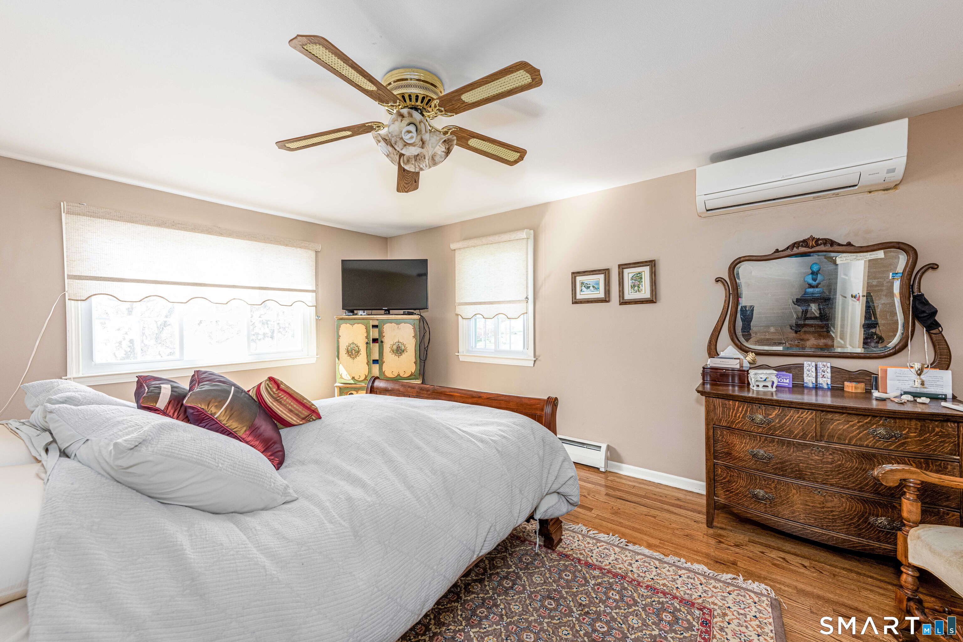 118 Rolling Ridge Road Hamden, CT 06518 - Photo 15 of 21 a bedroom with a bed and wooden floor