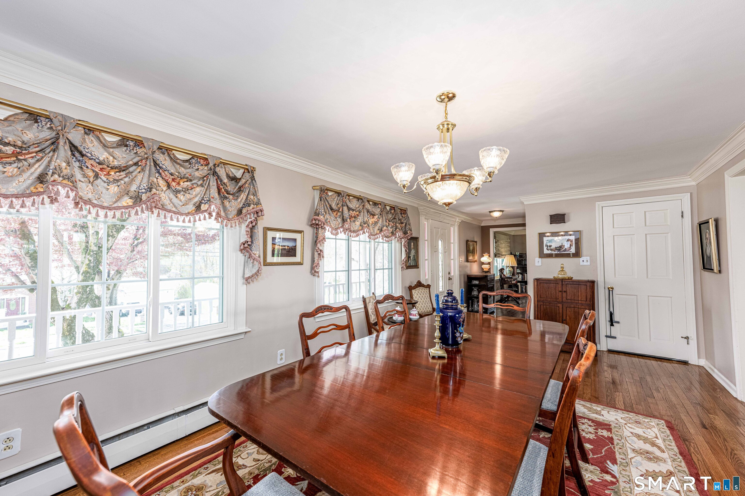 118 Rolling Ridge Road Hamden, CT 06518 - Photo 3 of 21 a dining room with wooden floor a chandelier a wooden table and chairs