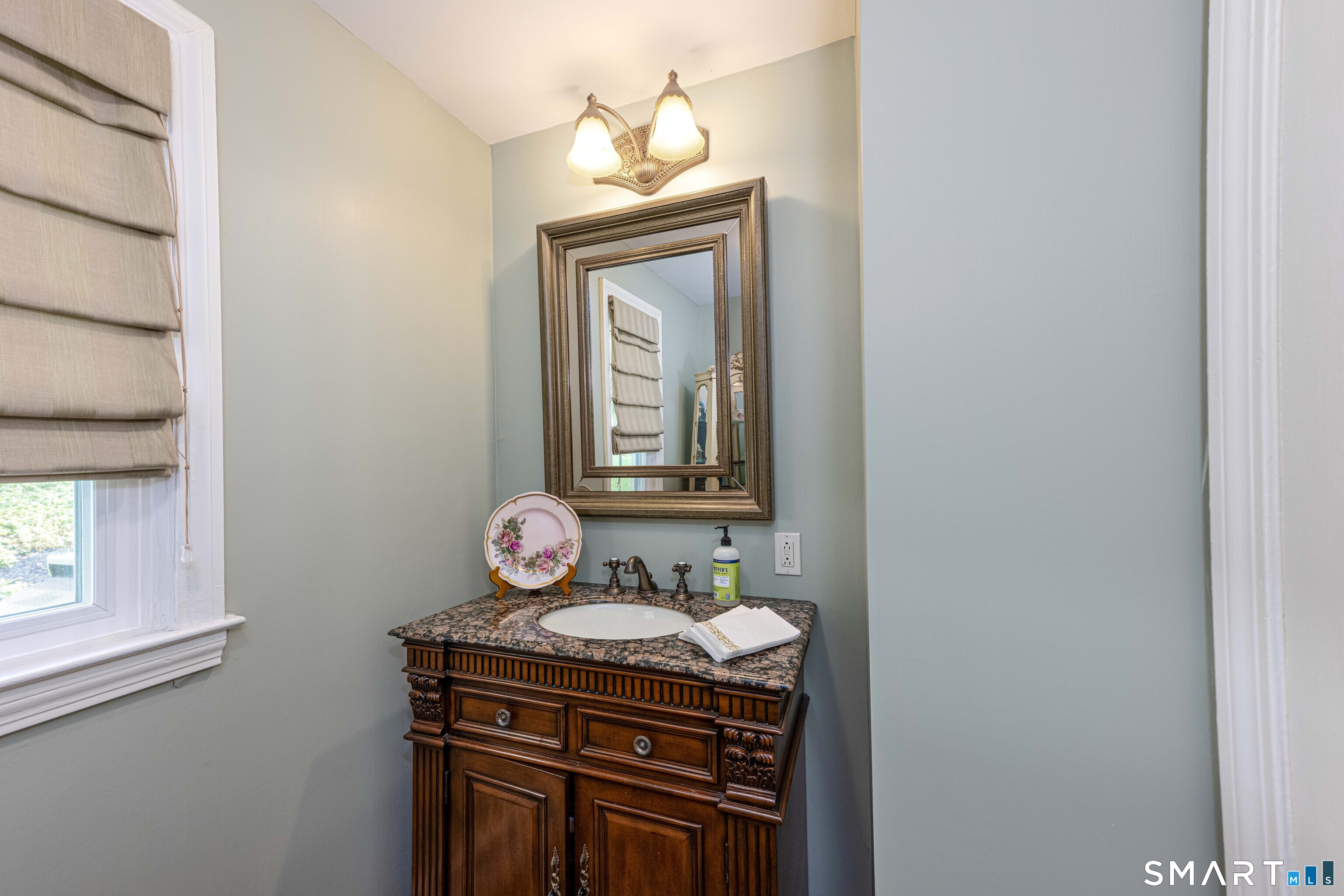 118 Rolling Ridge Road Hamden, CT 06518 - Photo 8 of 21 a bathroom with a granite countertop sink a mirror and a window