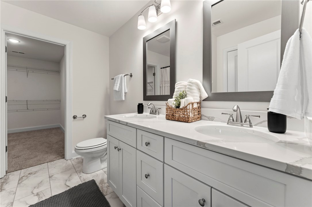 505 Fire Tower Road Williamston, SC 29697 - Photo 22 of 37 This bathroom features dual sinks and access to a spacious walk-in closet.