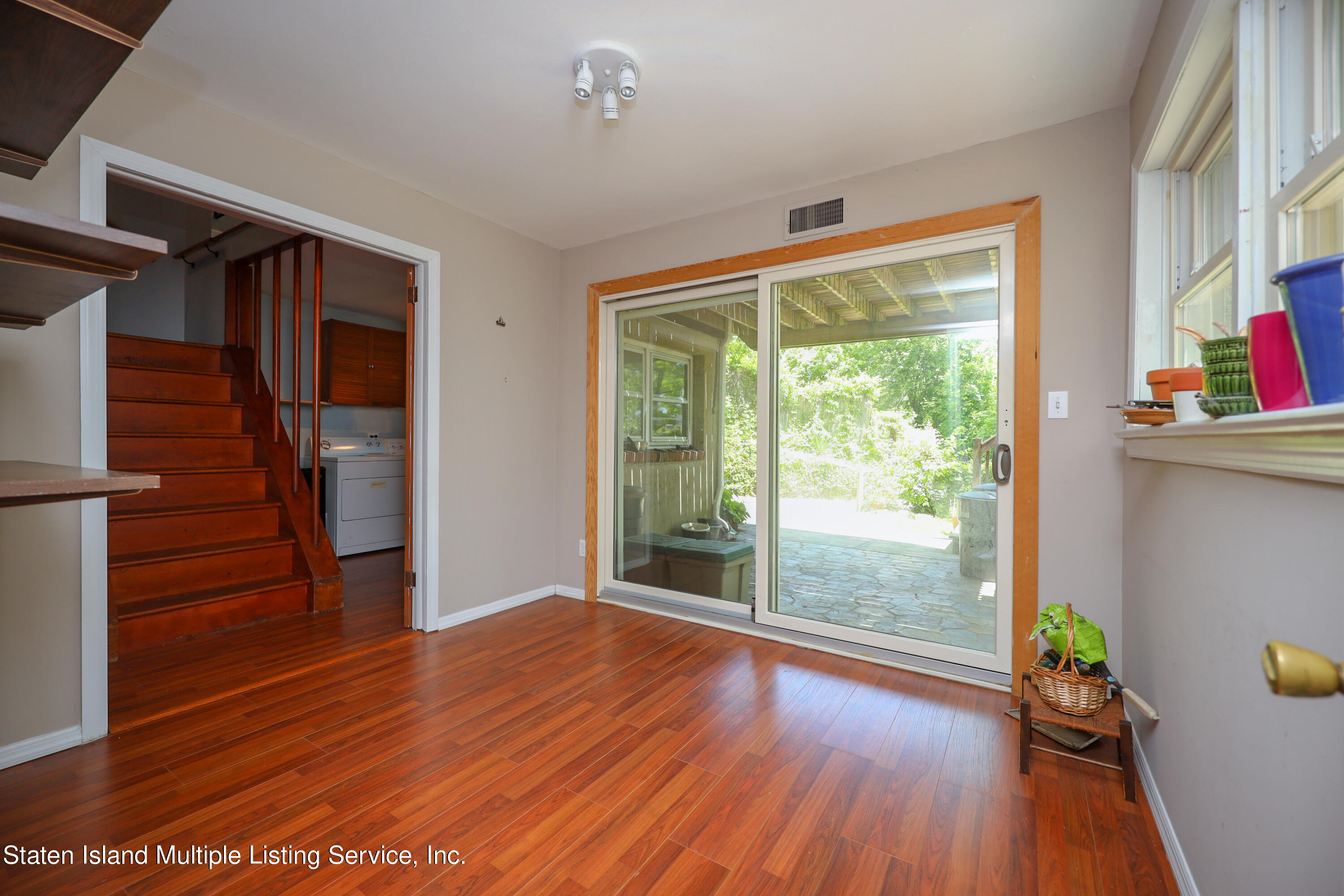 2209 Clove Road Staten Island, NY 10305 - Photo 15 of 38 wooden floor in an empty room with a window