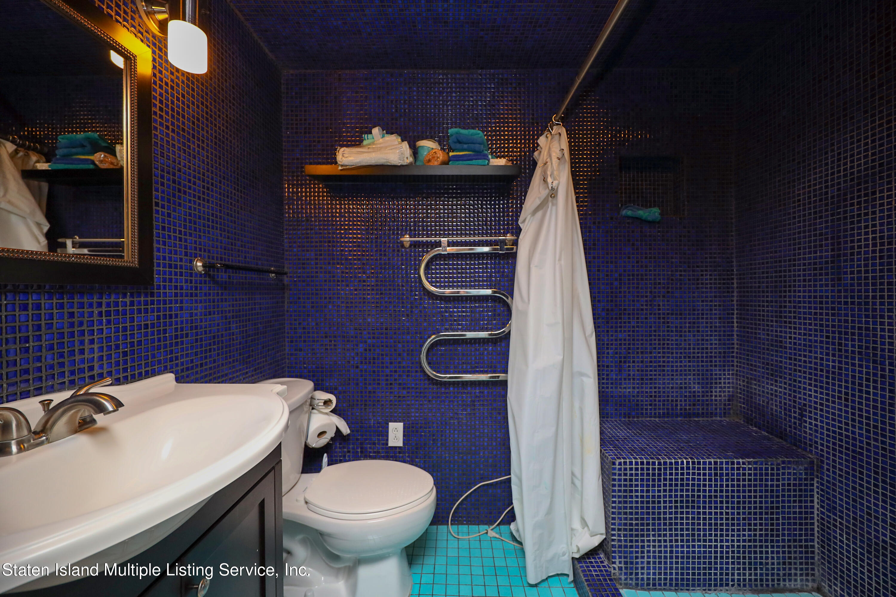 2209 Clove Road Staten Island, NY 10305 - Photo 18 of 38 a bathroom with a sink a toilet and shower