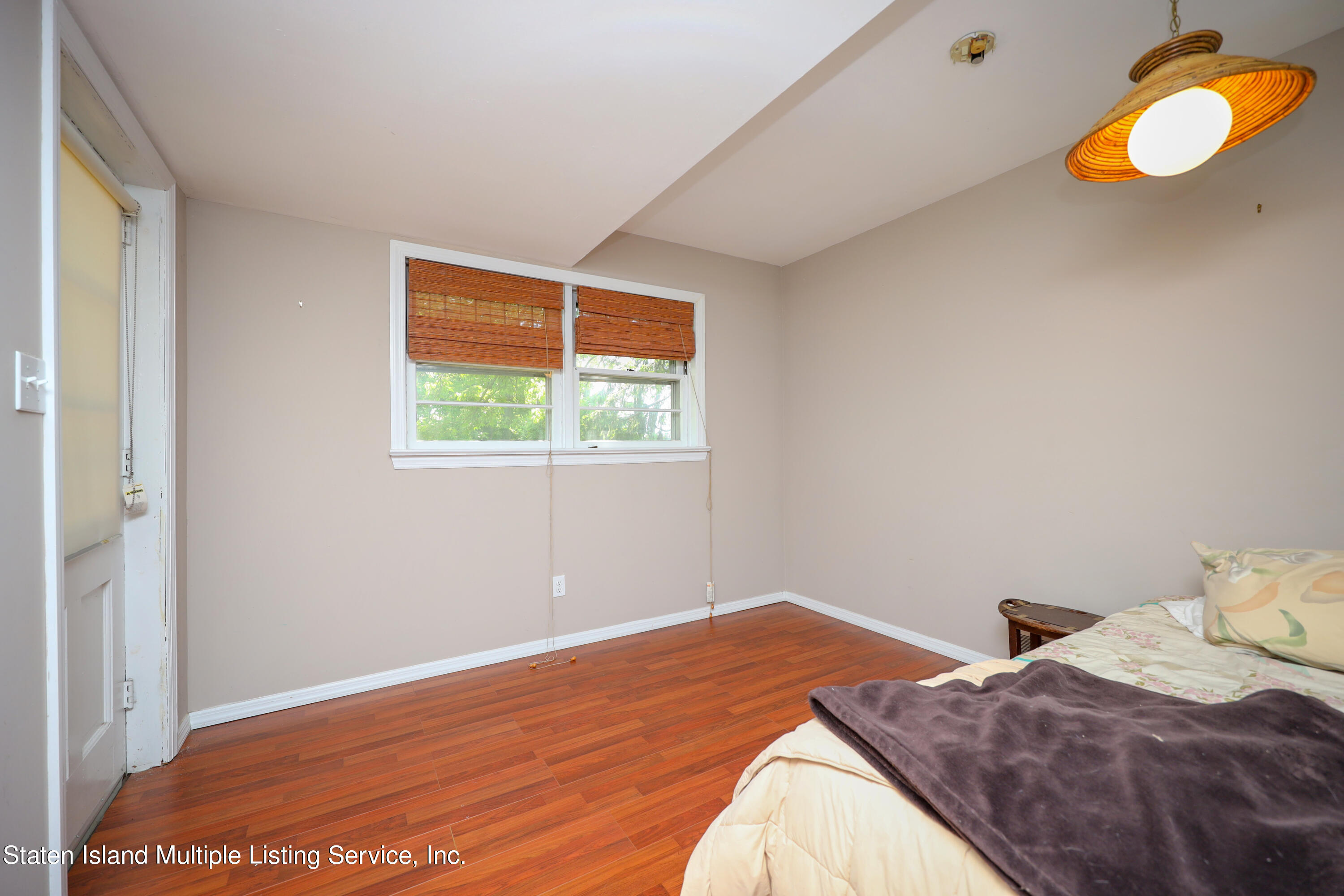 2209 Clove Road Staten Island, NY 10305 - Photo 19 of 38 a bedroom with a bed and a window