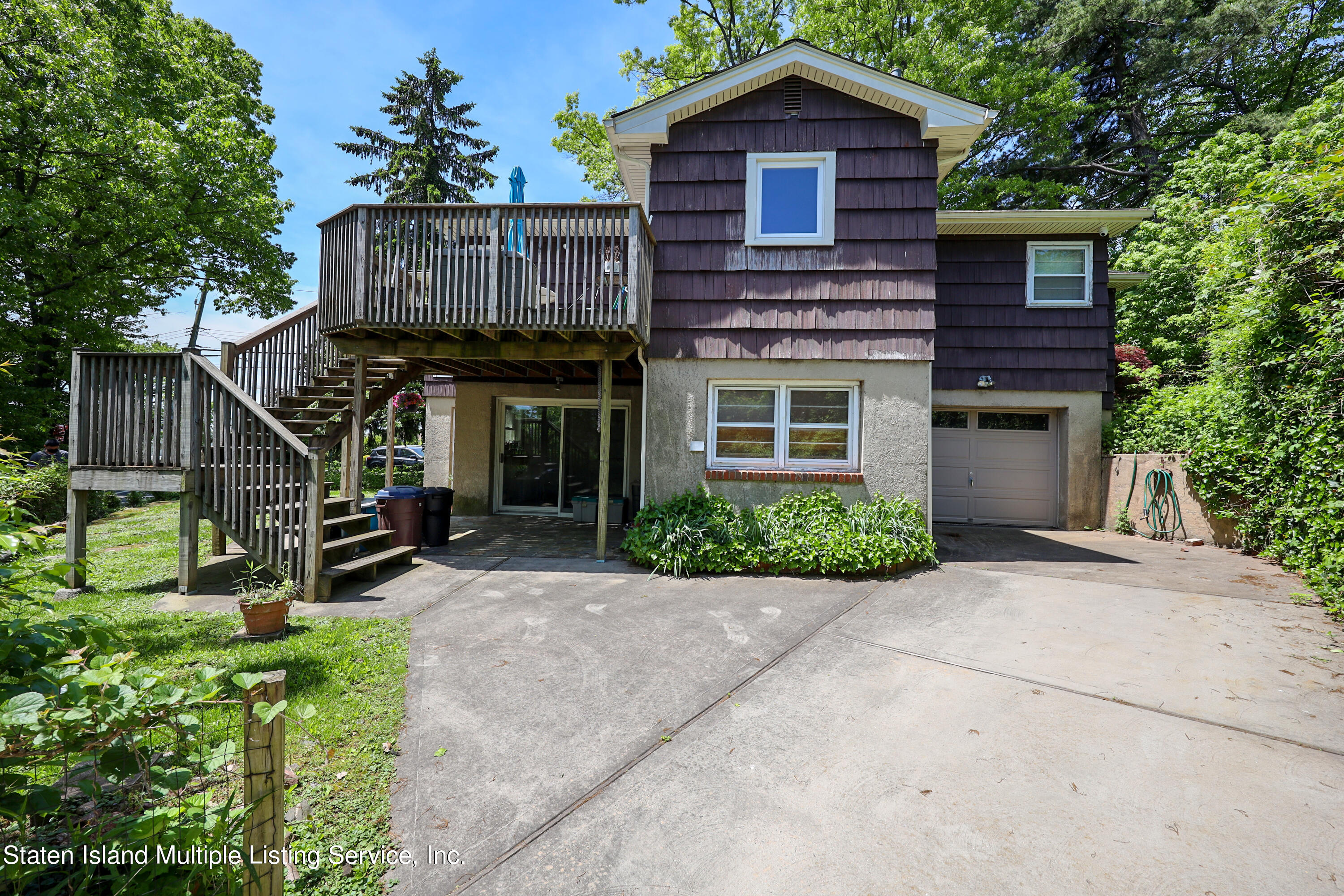2209 Clove Road Staten Island, NY 10305 - Photo 26 of 38 a view of a house with wooden deck and a yard