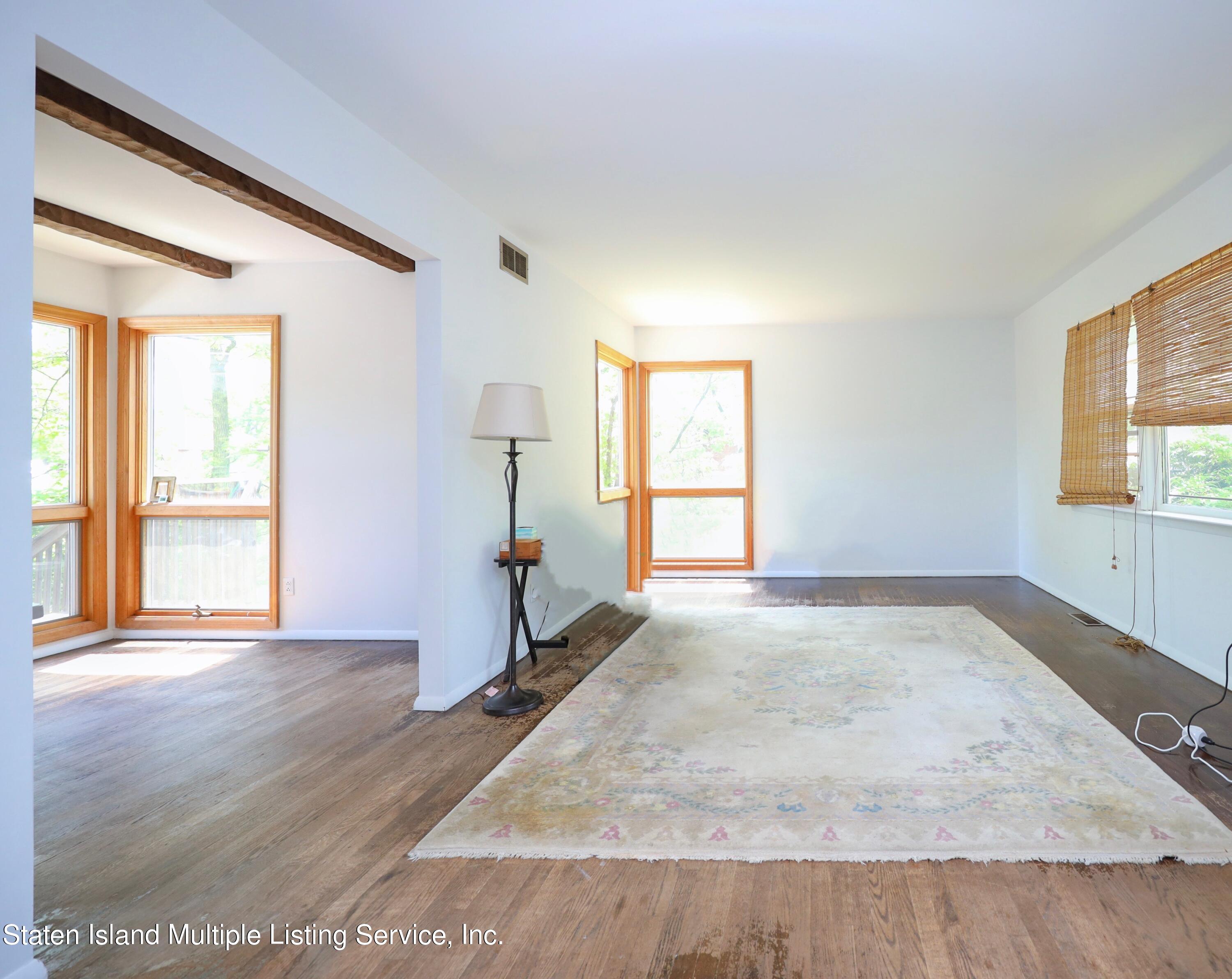 2209 Clove Road Staten Island, NY 10305 - Photo 5 of 38 an empty room with wooden floor and windows