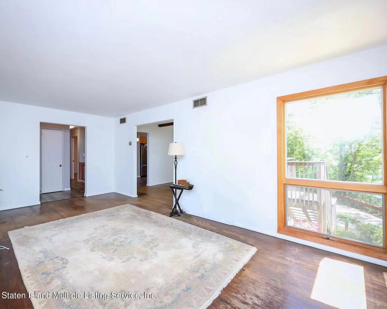 2209 Clove Road Staten Island, NY 10305 - Photo 6 of 38 a view of a livingroom with wooden floor and a large window