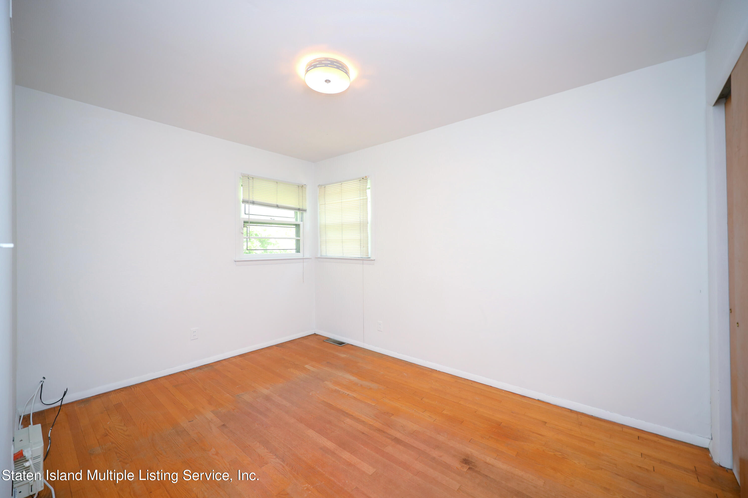 2209 Clove Road Staten Island, NY 10305 - Photo 10 of 38 an empty room with a window