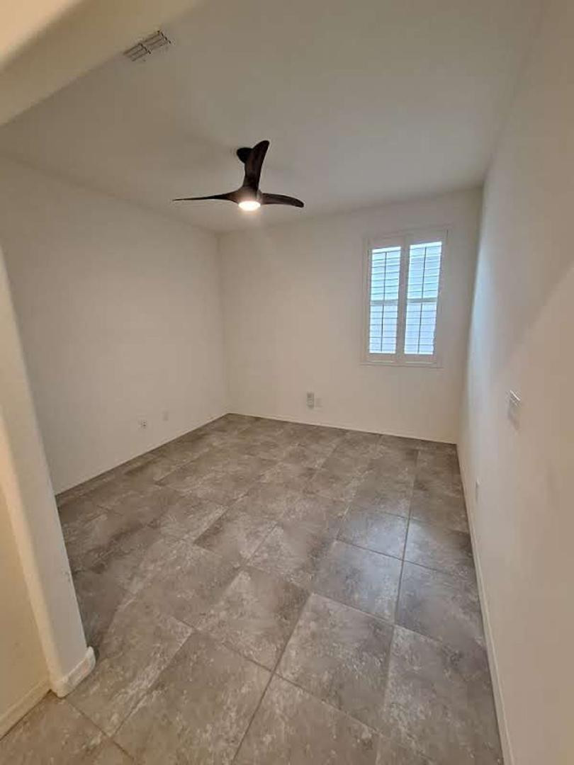 18541 West Mescal Street Surprise, AZ 85388 - Photo 17 of 31 an empty room with a ceiling fan and window
