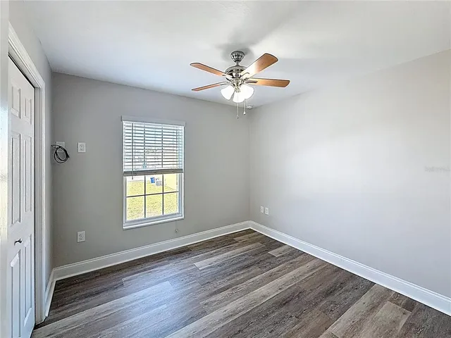 wooden floor in an empty room with a window