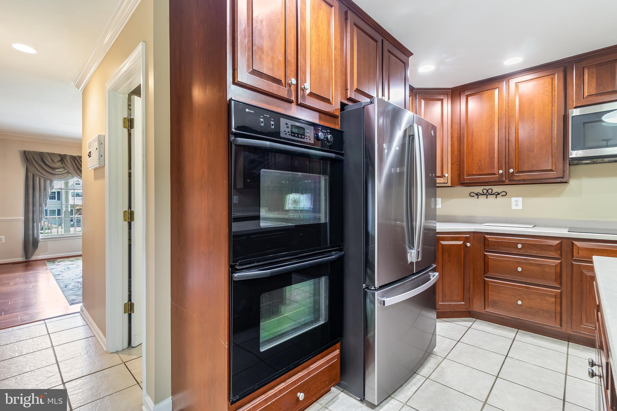 203 Morgans Ridge Court La Plata, MD 20646 - Photo 16 of 59 a kitchen with stainless steel appliances granite countertop a refrigerator and a stove top oven