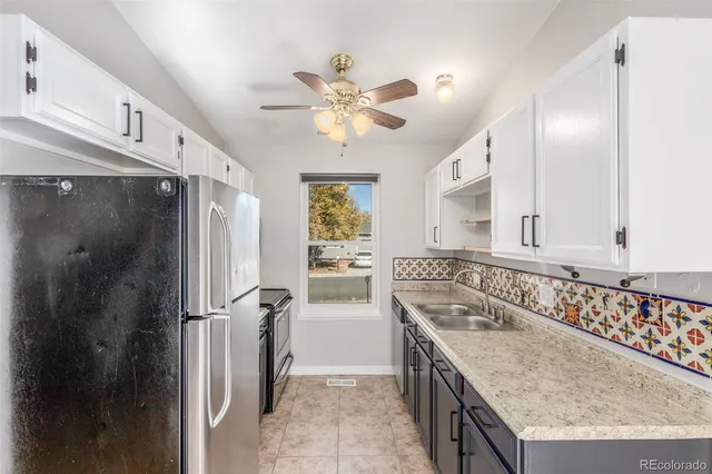 a kitchen with a sink a counter top space and stainless steel appliances