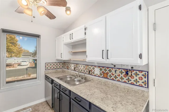 a bathroom with a granite countertop sink a window and a mirror