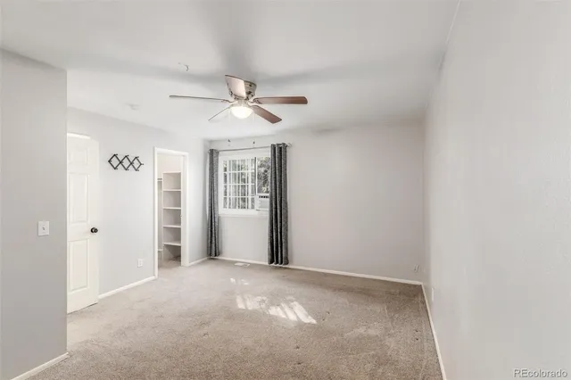 a view of a livingroom with a ceiling fan and window