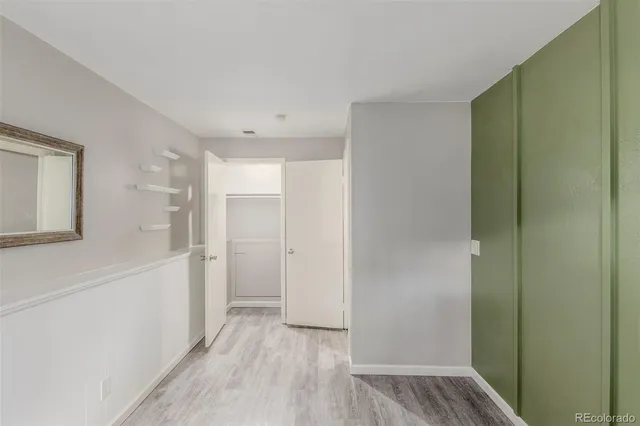 a view of hallway with wooden floor