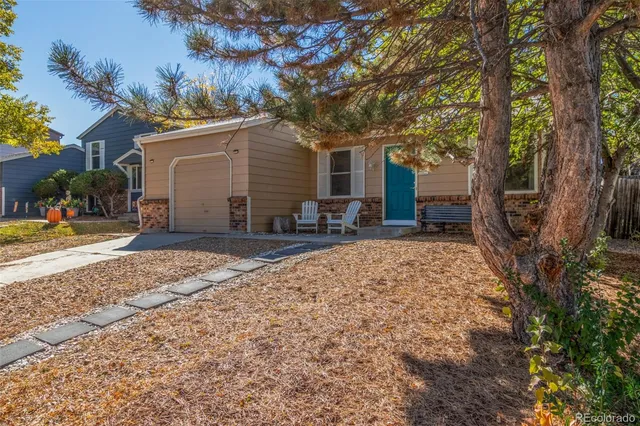 a backyard of a house with yard and outdoor seating