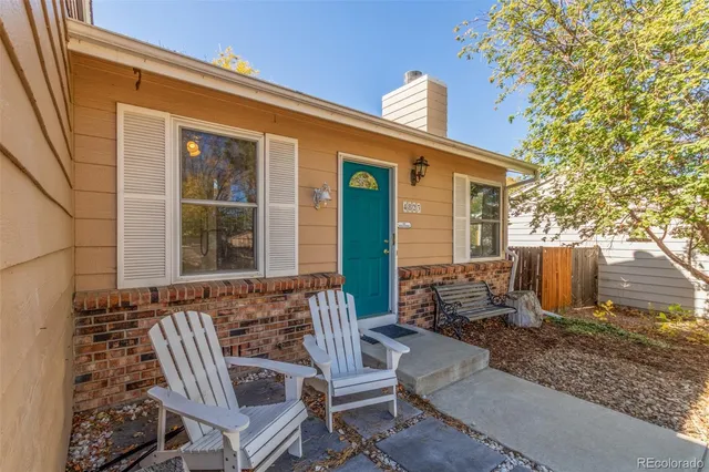 a view of a patio with table and chairs with wooden fence and plants