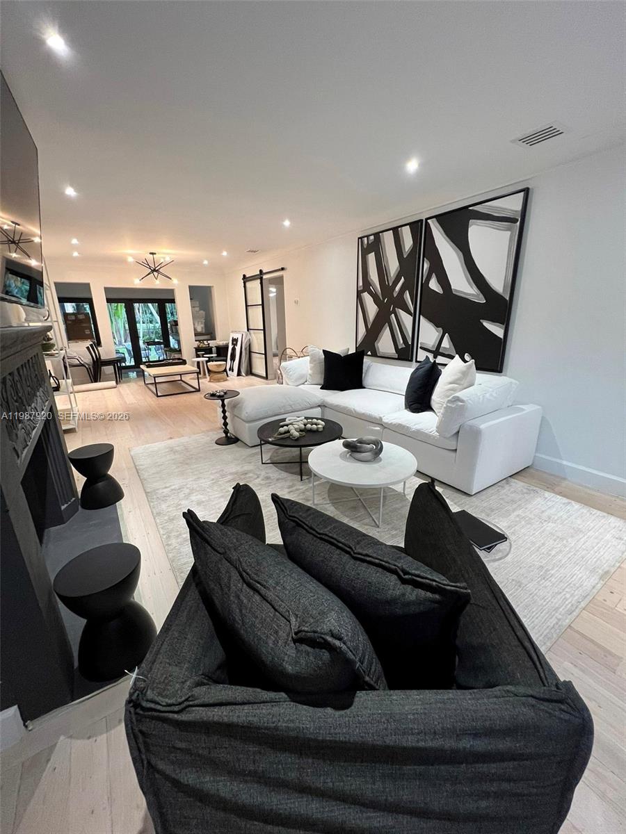 5173 Alton Road Miami Beach, FL 33140 - Photo 4 of 18 a living room with furniture and a wooden floor