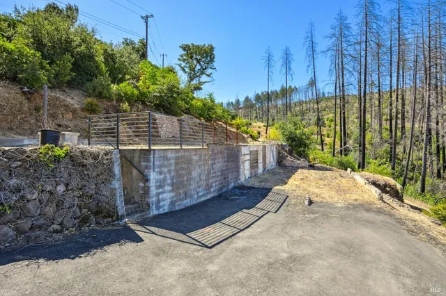 a view of a backyard with wooden fence