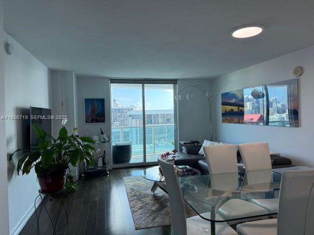2101 Brickell Avenue, Unit 2002 Miami, FL 33129 - Photo 4 of 7 a living room with furniture potted plant floor and a flat screen tv