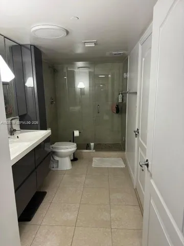 a hallway with a couch and a potted plant