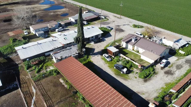 an aerial view of multiple houses with yard