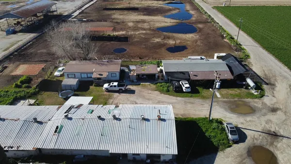 an aerial view of a houses with street