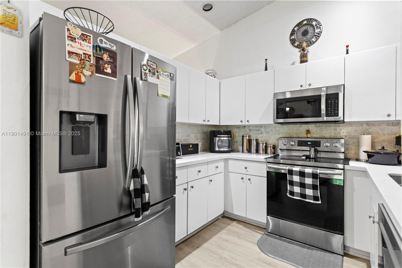 17320 Northwest 66th Place Hialeah, FL 33015 - Photo 13 of 47 a kitchen with stainless steel appliances granite countertop a refrigerator a stove a sink and a microwave