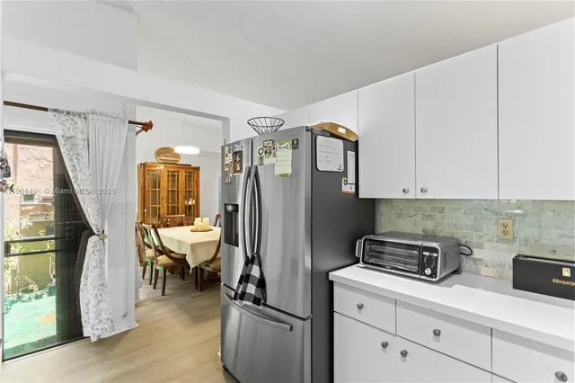 a living room with furniture a flat screen tv and a table