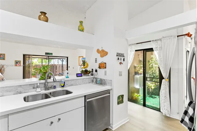 a view of a hallway with wooden floor and workspace