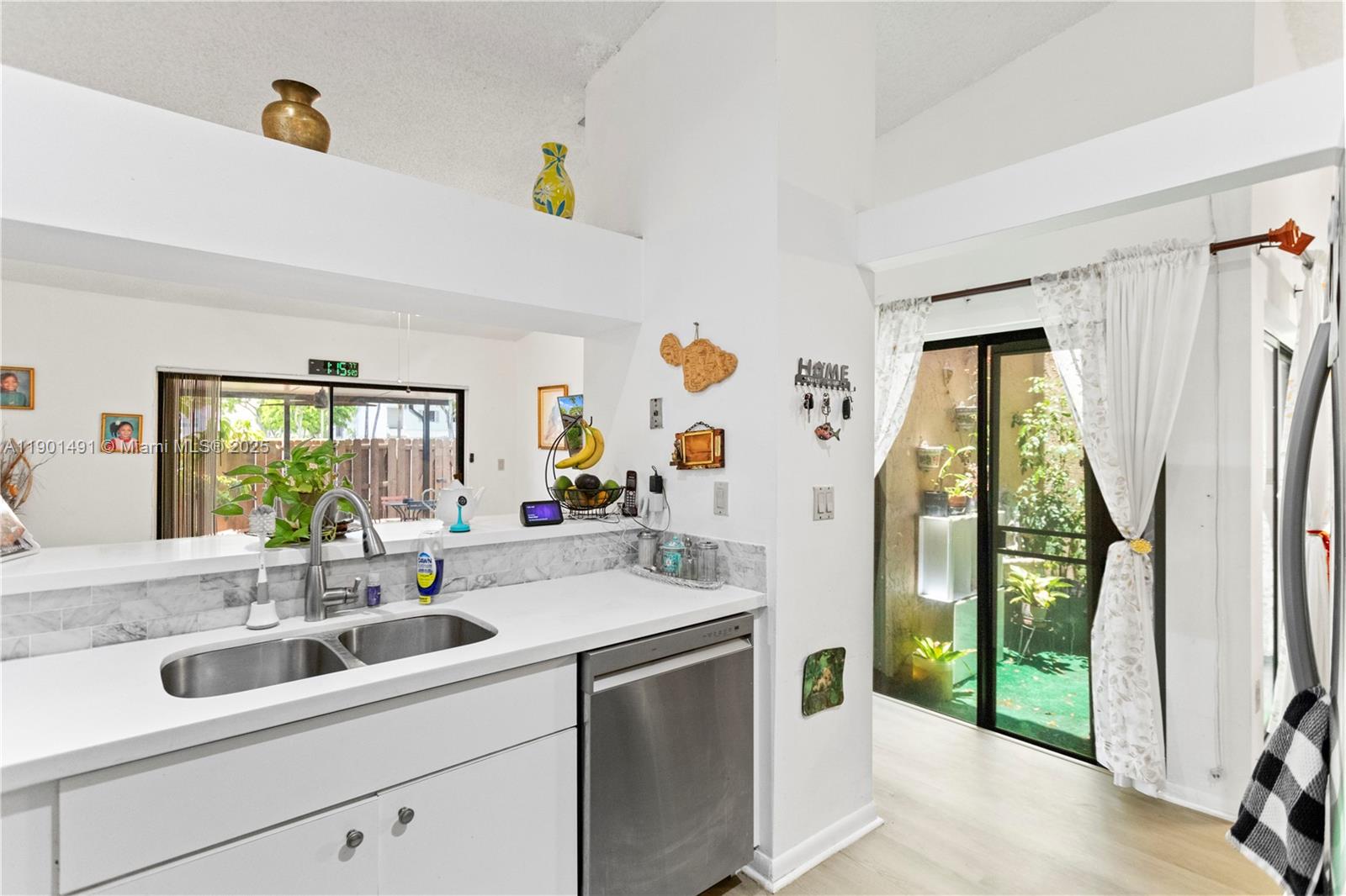 17320 Northwest 66th Place Hialeah, FL 33015 - Photo 16 of 47 a view with a sink and mirror next to a window