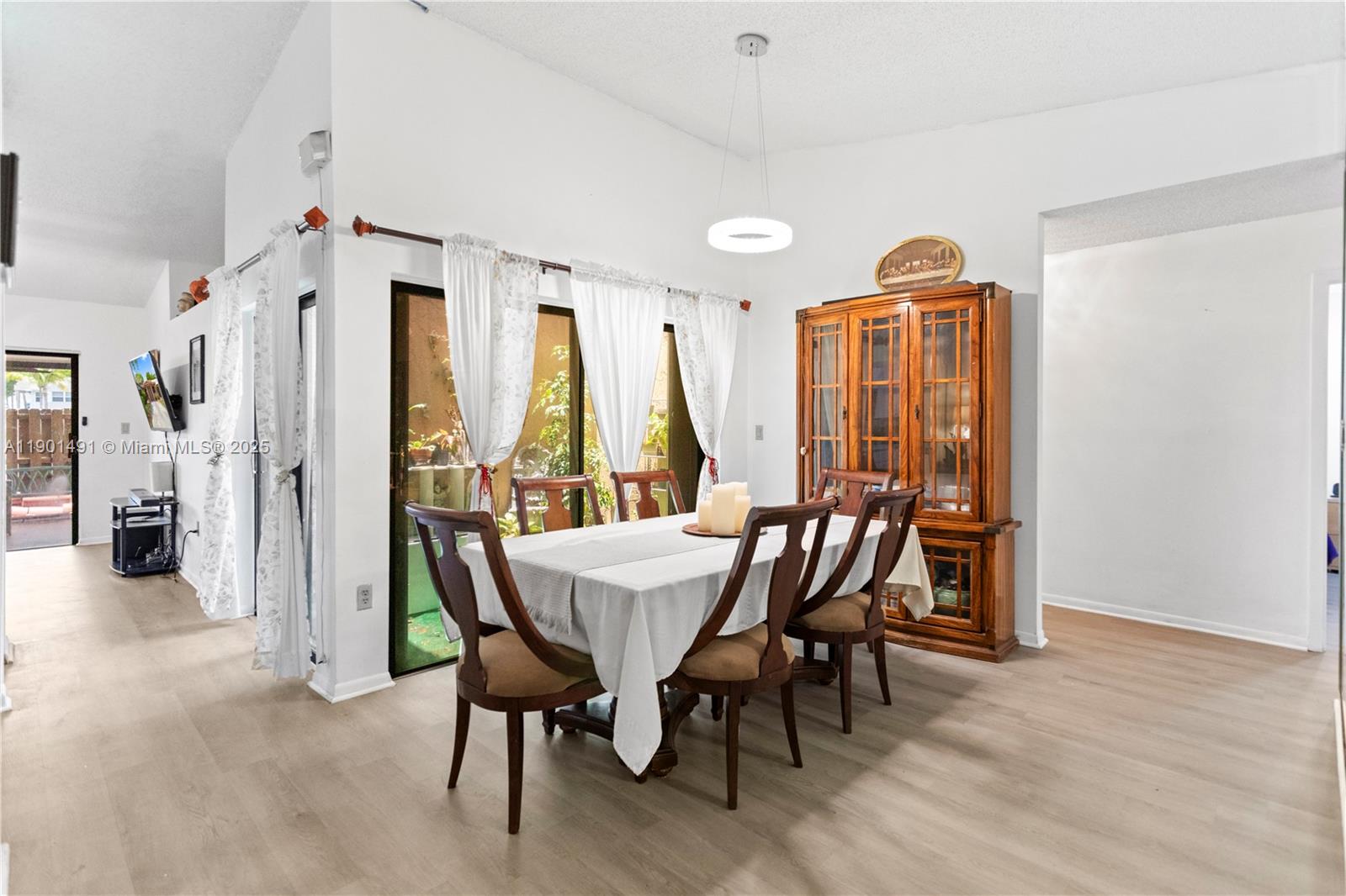 17320 Northwest 66th Place Hialeah, FL 33015 - Photo 19 of 47 a view of a dining room with furniture window and wooden floor