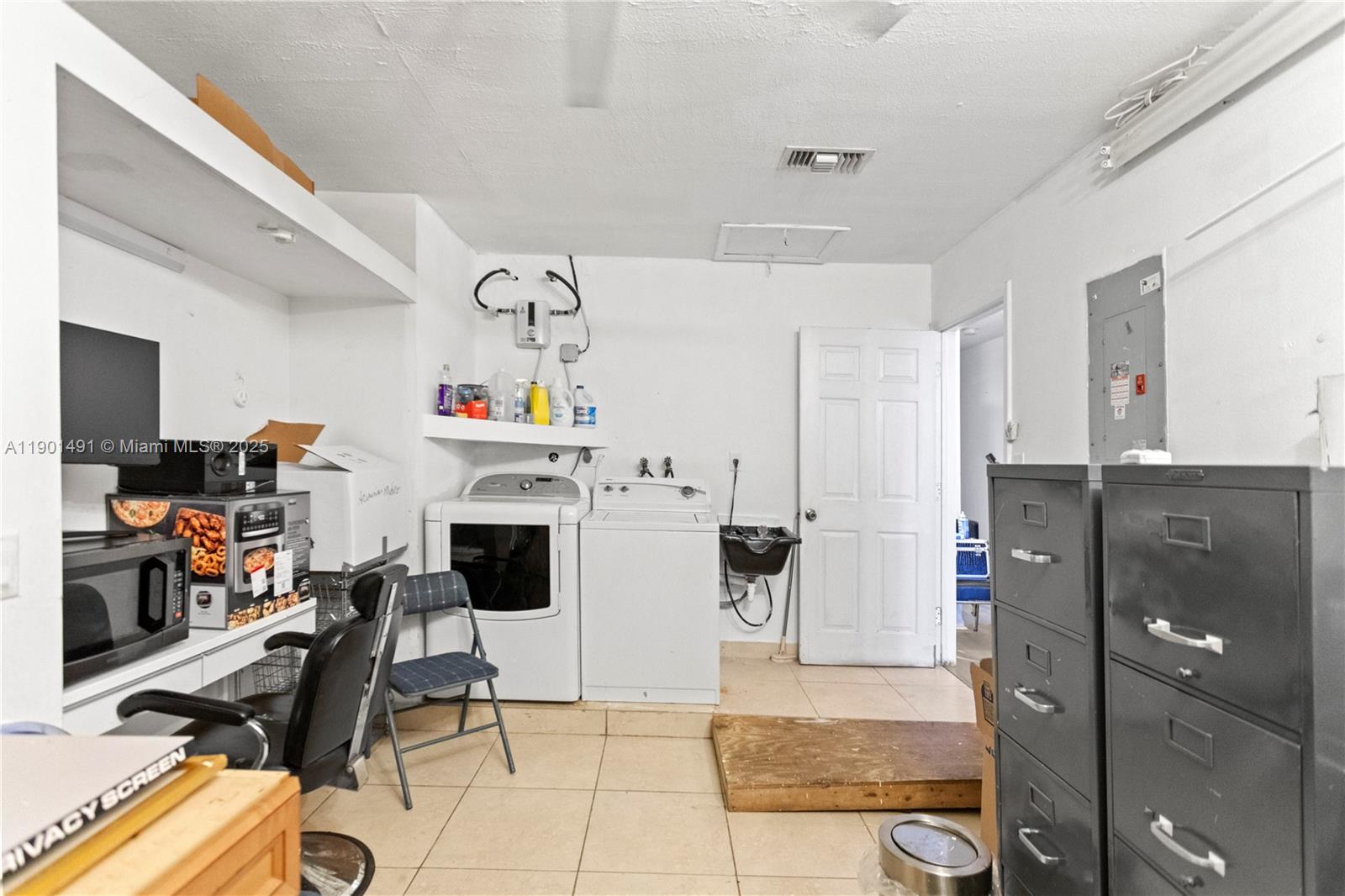 17320 Northwest 66th Place Hialeah, FL 33015 - Photo 20 of 47 a living room with furniture a flat screen tv and a table