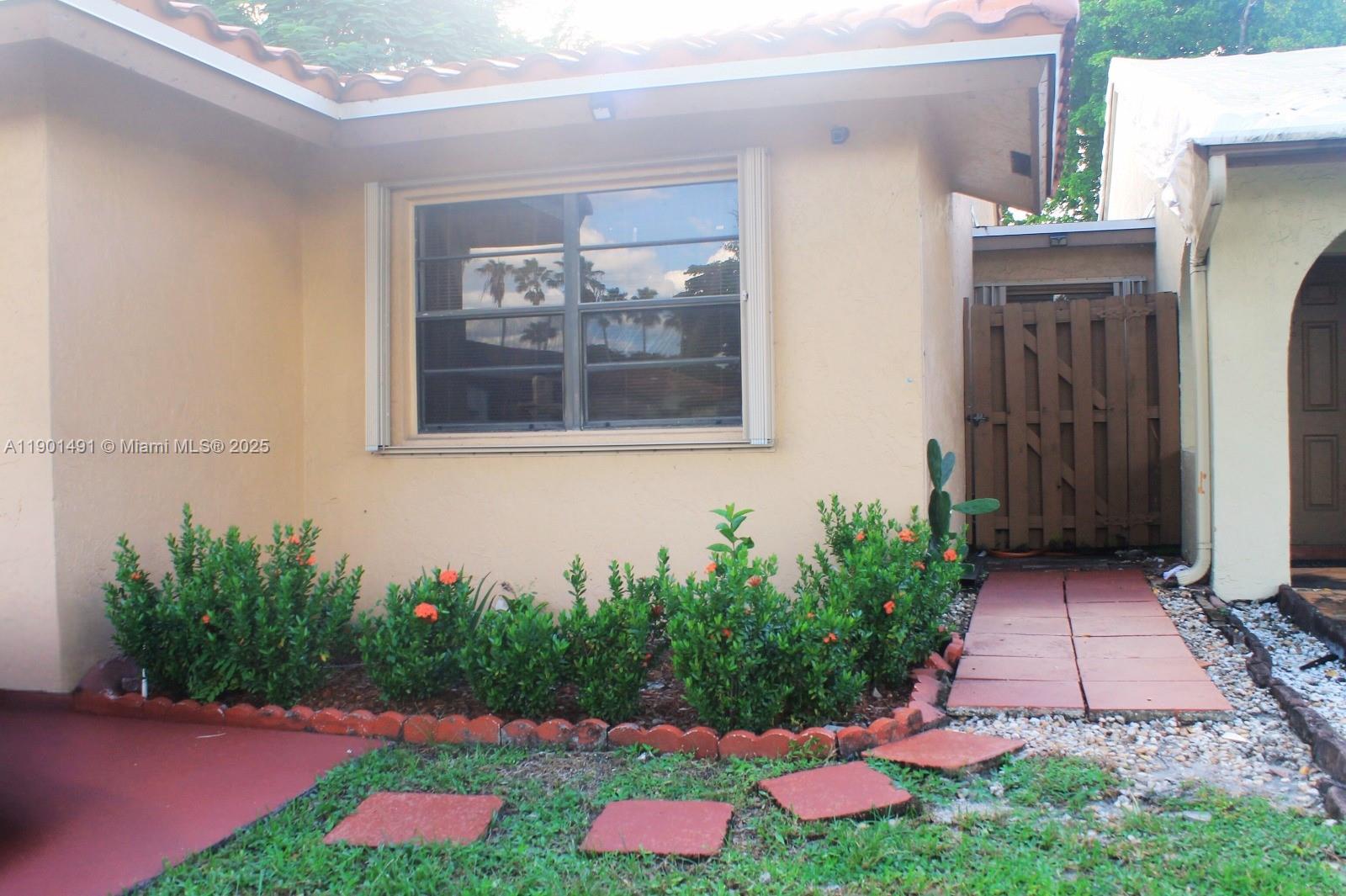 17320 Northwest 66th Place Hialeah, FL 33015 - Photo 2 of 47 a front view of a house with yard