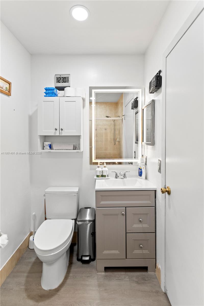 17320 Northwest 66th Place Hialeah, FL 33015 - Photo 22 of 47 a bathroom with a toilet a sink and mirror