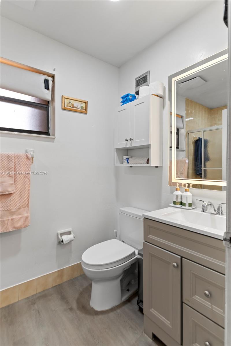 17320 Northwest 66th Place Hialeah, FL 33015 - Photo 23 of 47 a bathroom with a toilet a sink and mirror