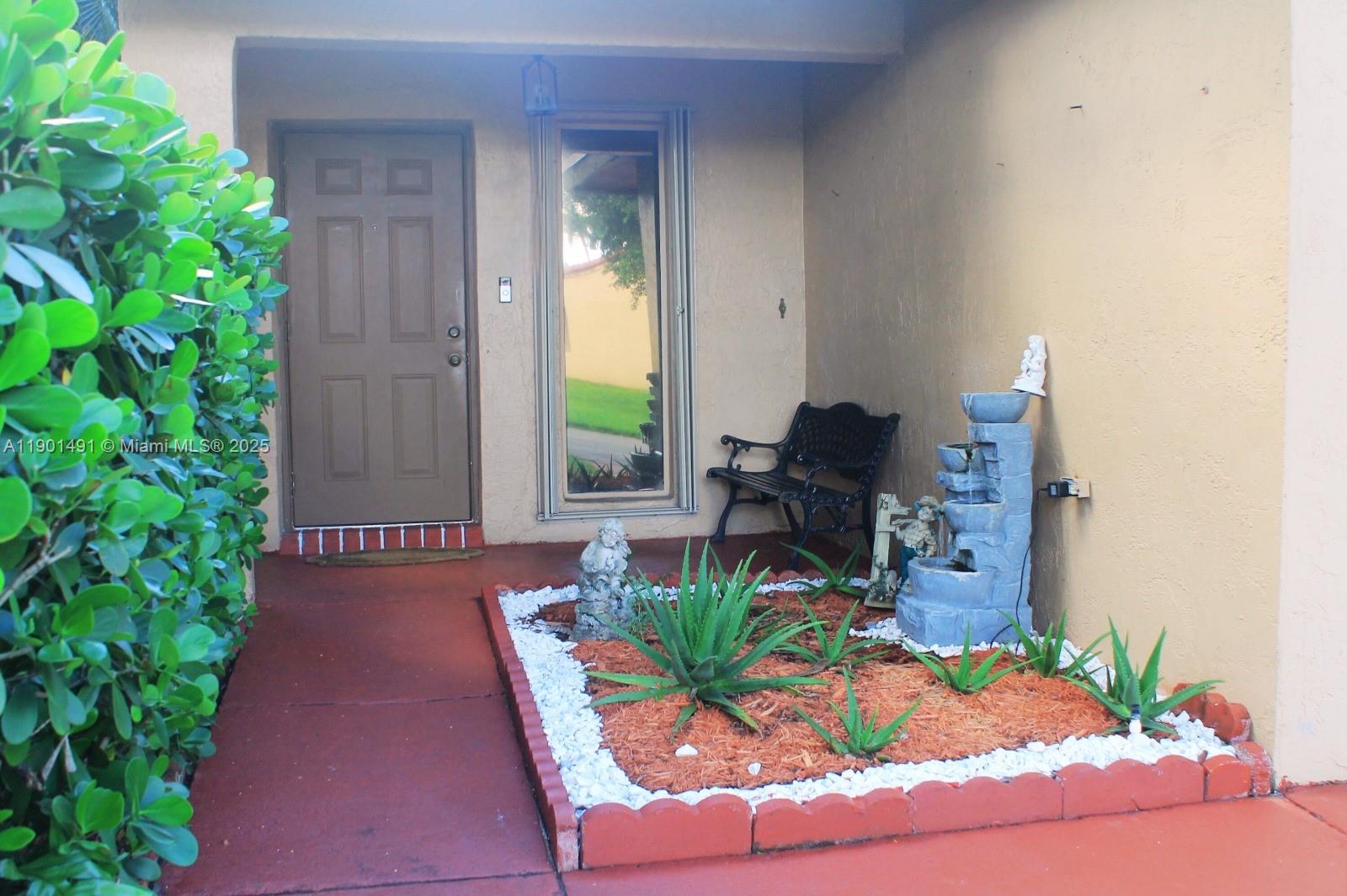 17320 Northwest 66th Place Hialeah, FL 33015 - Photo 3 of 47 a front view of a house with patio