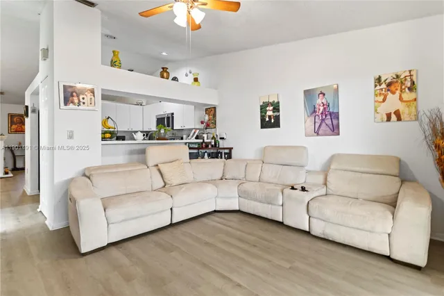 a kitchen with stainless steel appliances granite countertop a refrigerator a stove a sink and a microwave