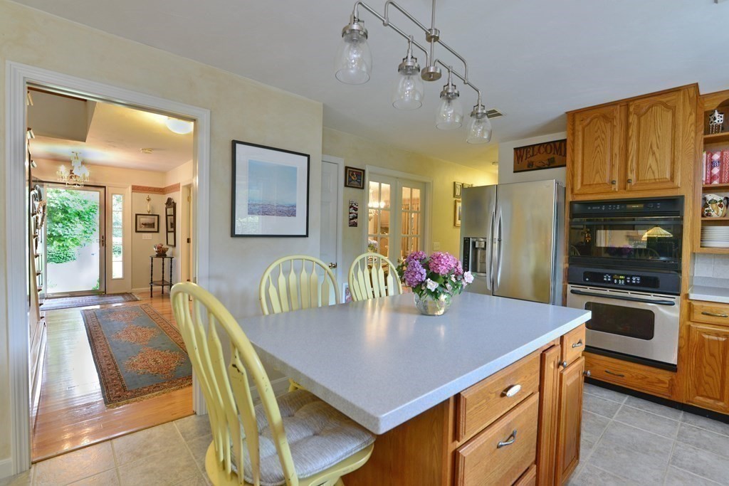 387 High Street Rochester, MA 02770 - Photo 13 of 39 a kitchen with a dining table and chairs