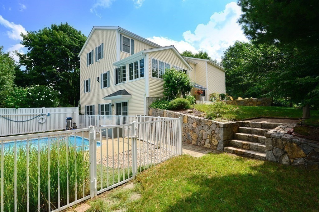387 High Street Rochester, MA 02770 - Photo 3 of 39 a view of a white house with a small yard plants and large trees
