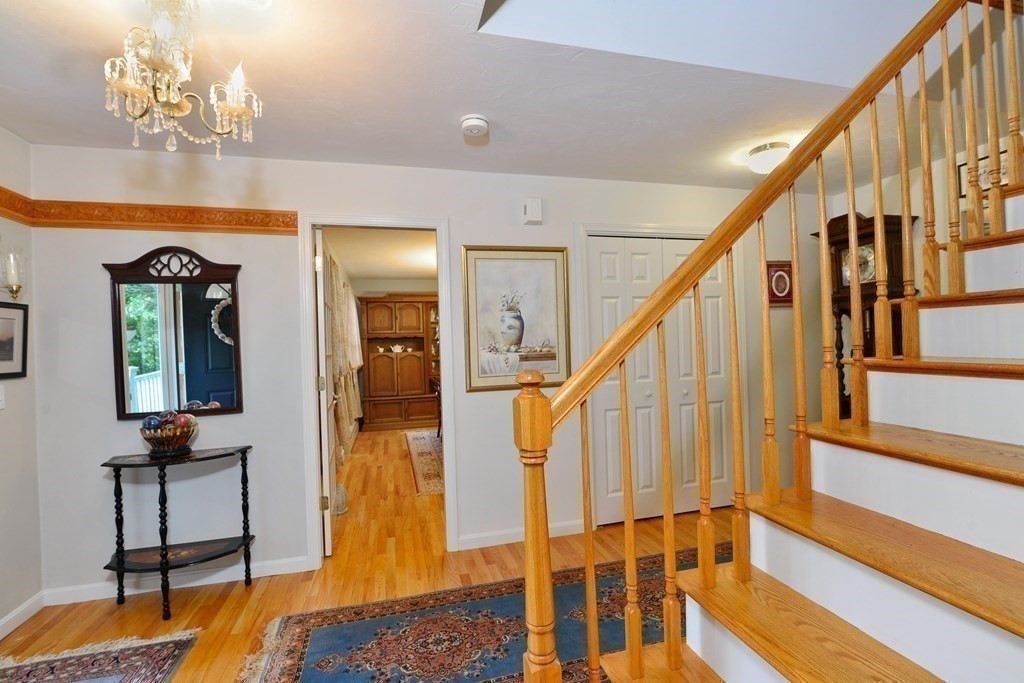 387 High Street Rochester, MA 02770 - Photo 8 of 39 a view of a hallway with wooden floor and staircase