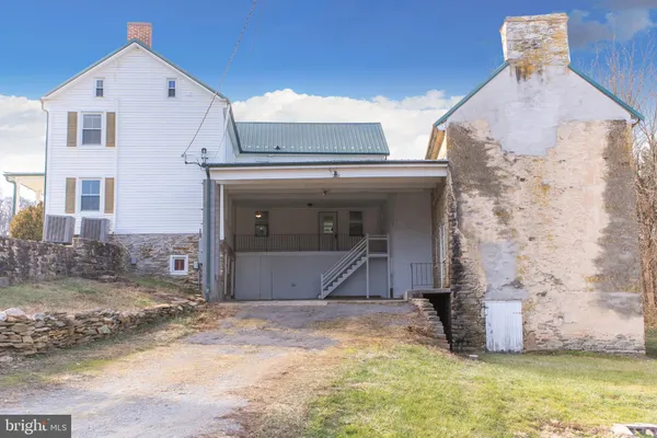 a bed with a white comforter and pillows