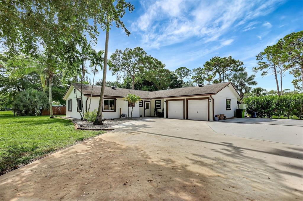 14916 22nd Road North Loxahatchee, FL 33470 - Photo 1 of 1 a front view of house with yard and trees