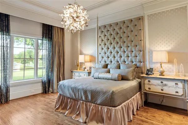 a bedroom with a bed and a chandelier