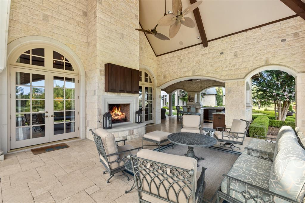 1201 Gray Branch Road McKinney, TX 75071 - Photo 36 of 40 a living room with furniture a fireplace and a flat screen tv