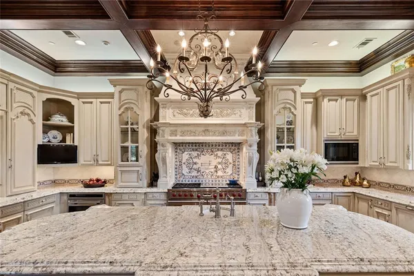 a living room with fireplace furniture and a potted plant