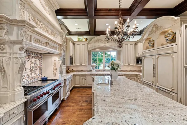 a kitchen with stainless steel appliances granite countertop a stove a sink and a refrigerator