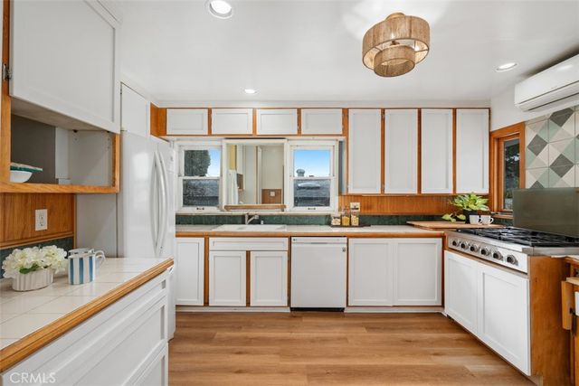 a large kitchen with stainless steel appliances granite countertop a stove and a sink