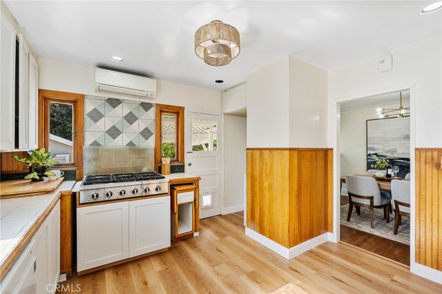 a view of a kitchen with fridge and wooden floor