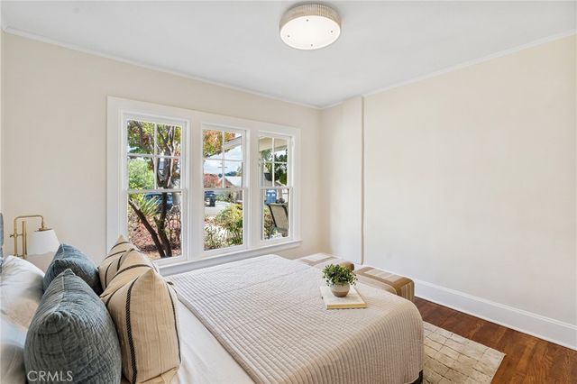 a bed sitting in a bedroom next to a window