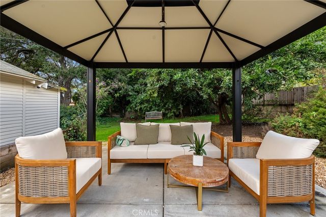 a view of a patio with a table and chairs under an umbrella